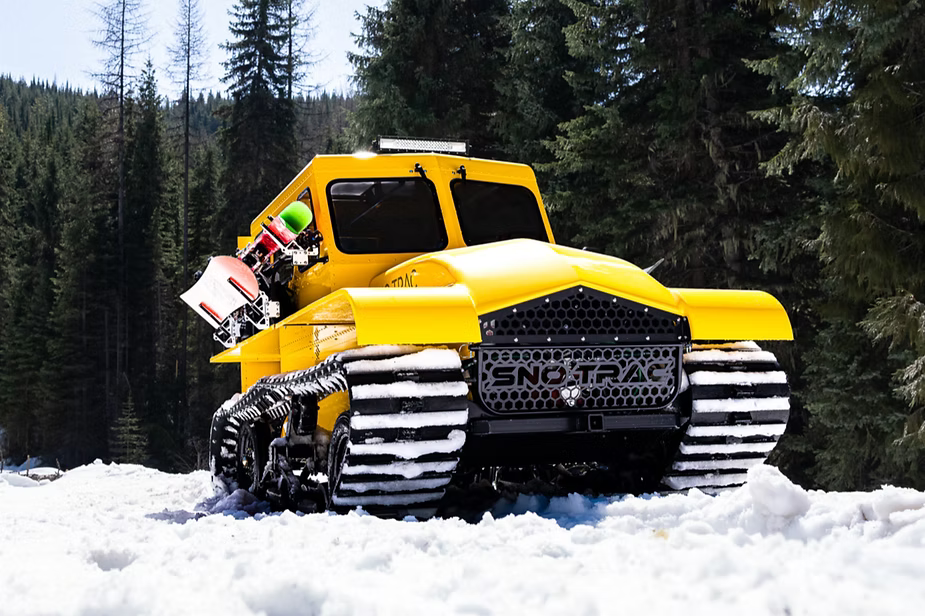 Yellow Sno Trac on snowy hilltop