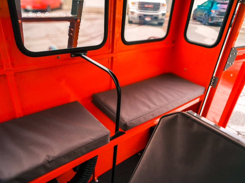 Interior padded bench seating inside recreation vehicle Sno Trac.