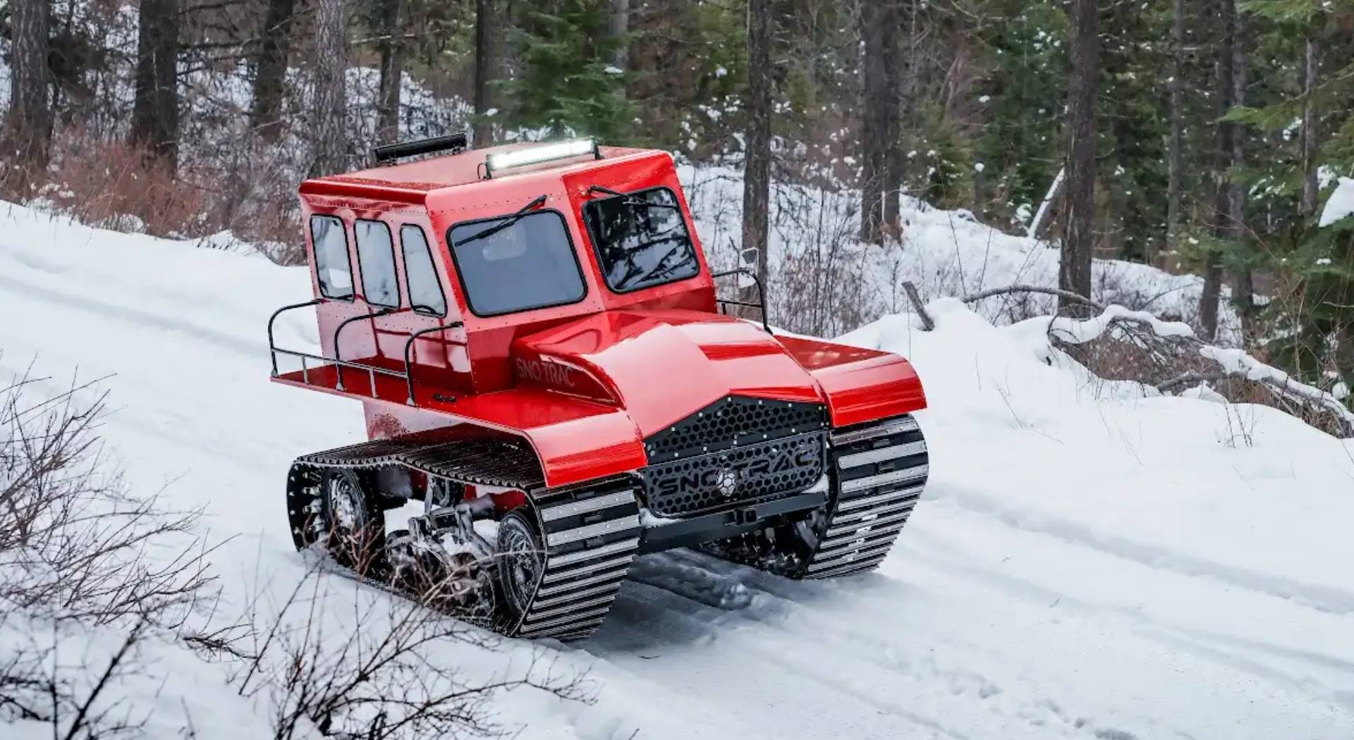 Red Sno Trac on a snowy trail through forest