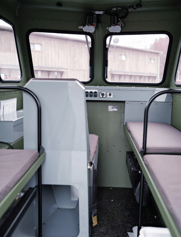 Early model Sno Trac cab interior shown.