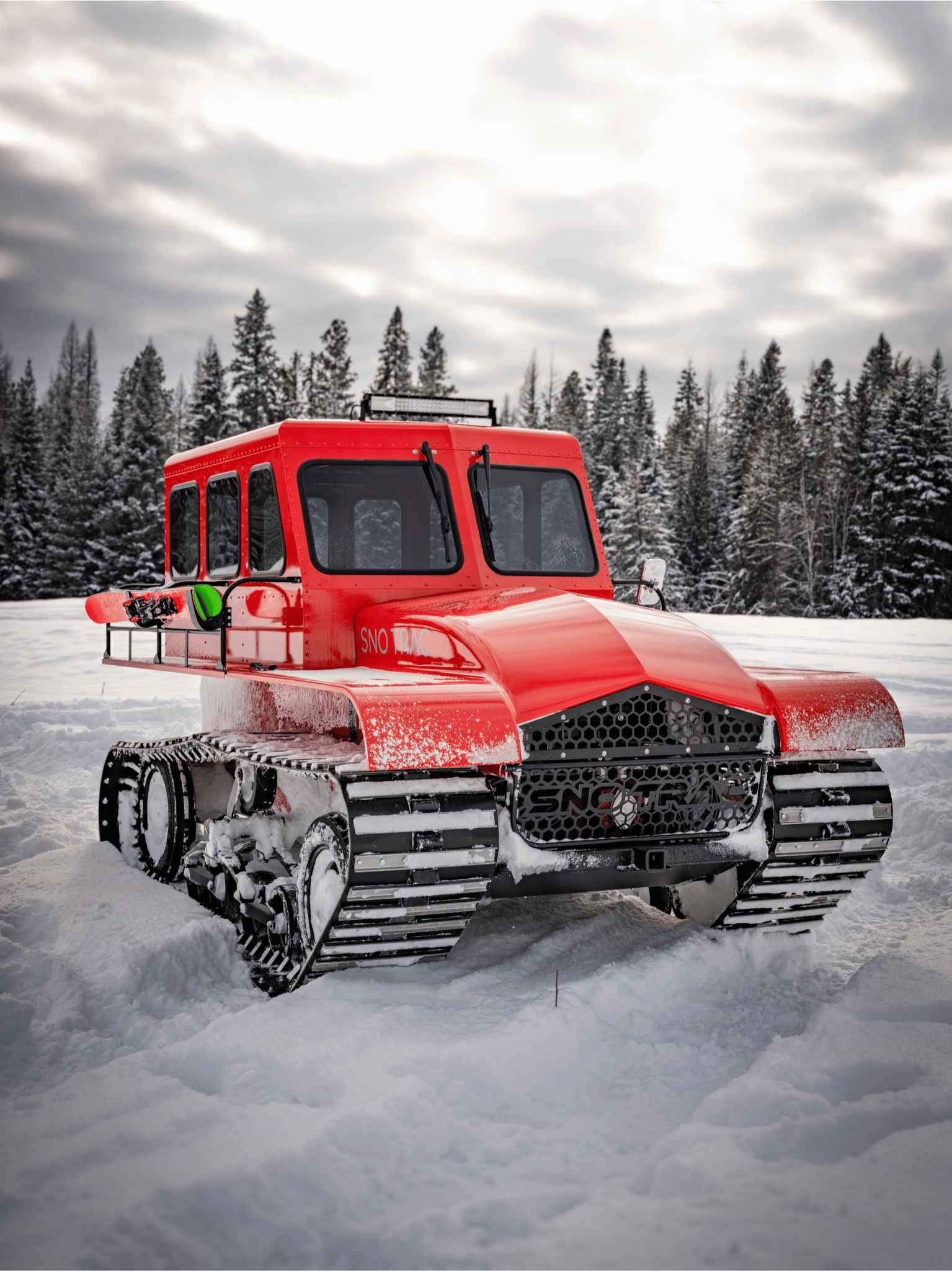 Red snowcat in deep snow landscape.