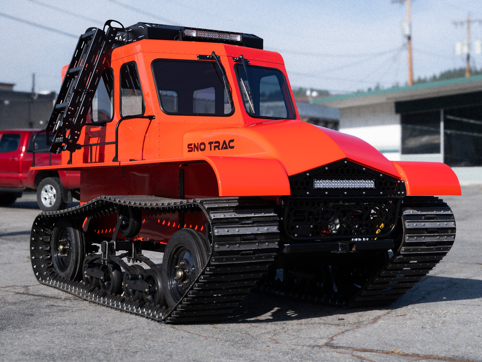 Orange Sno Trac vehicle at headquarters