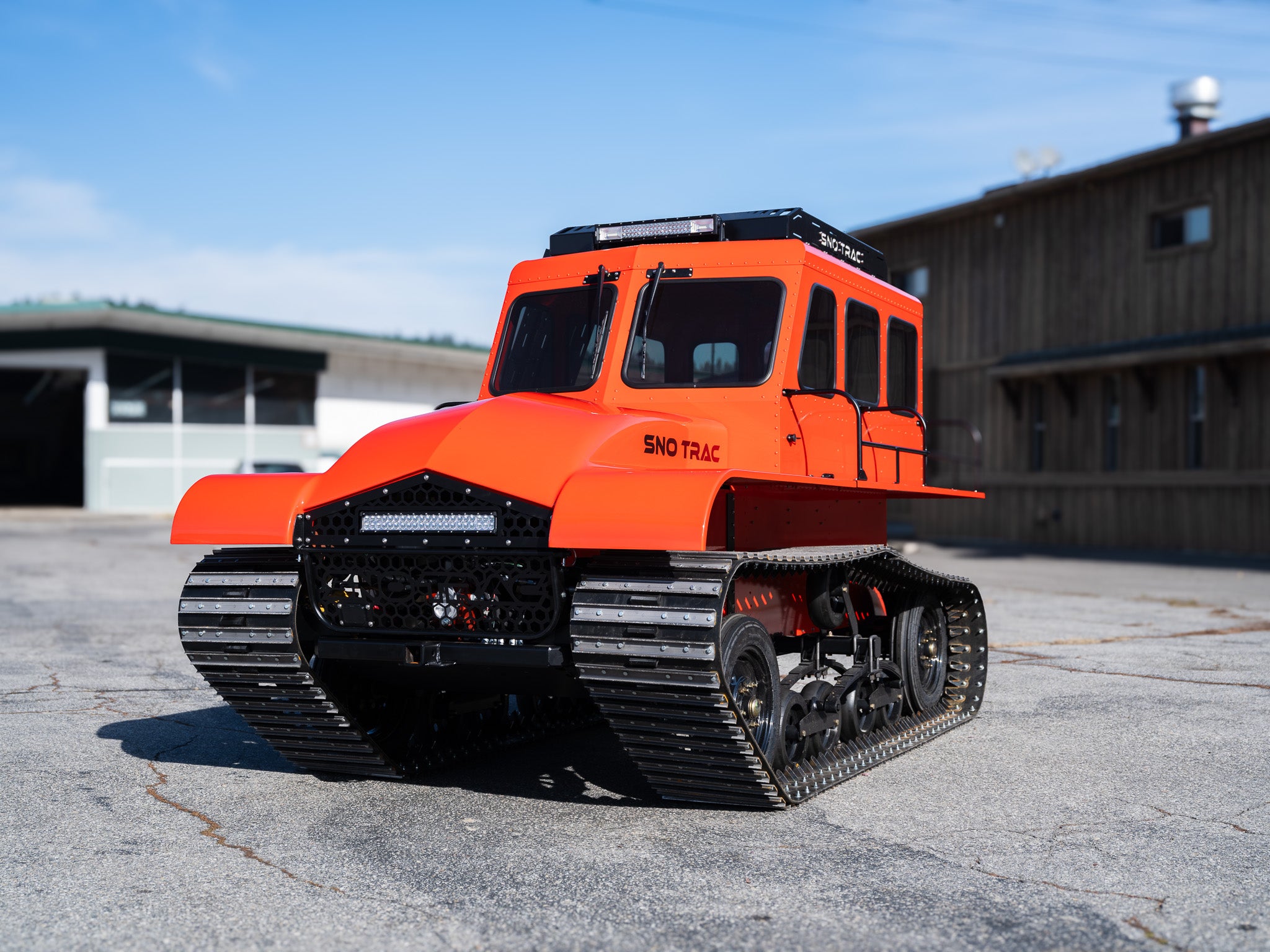 Tracked snow vehicle in orange Sno Trac