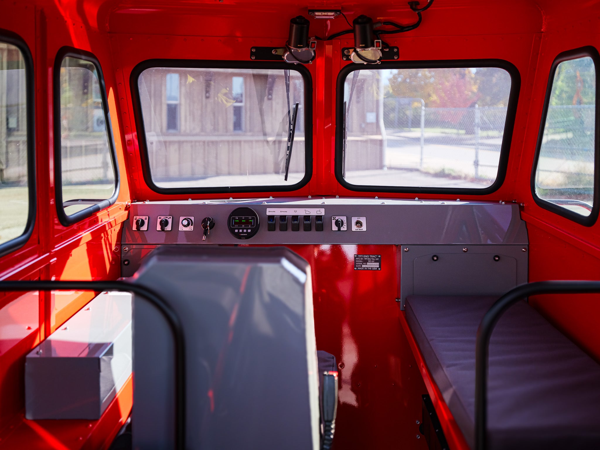 Red Sno Trac cab interior view shown.